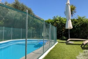 Code-compliant aluminum pool fence surrounding backyard pool in Lake Forest IL